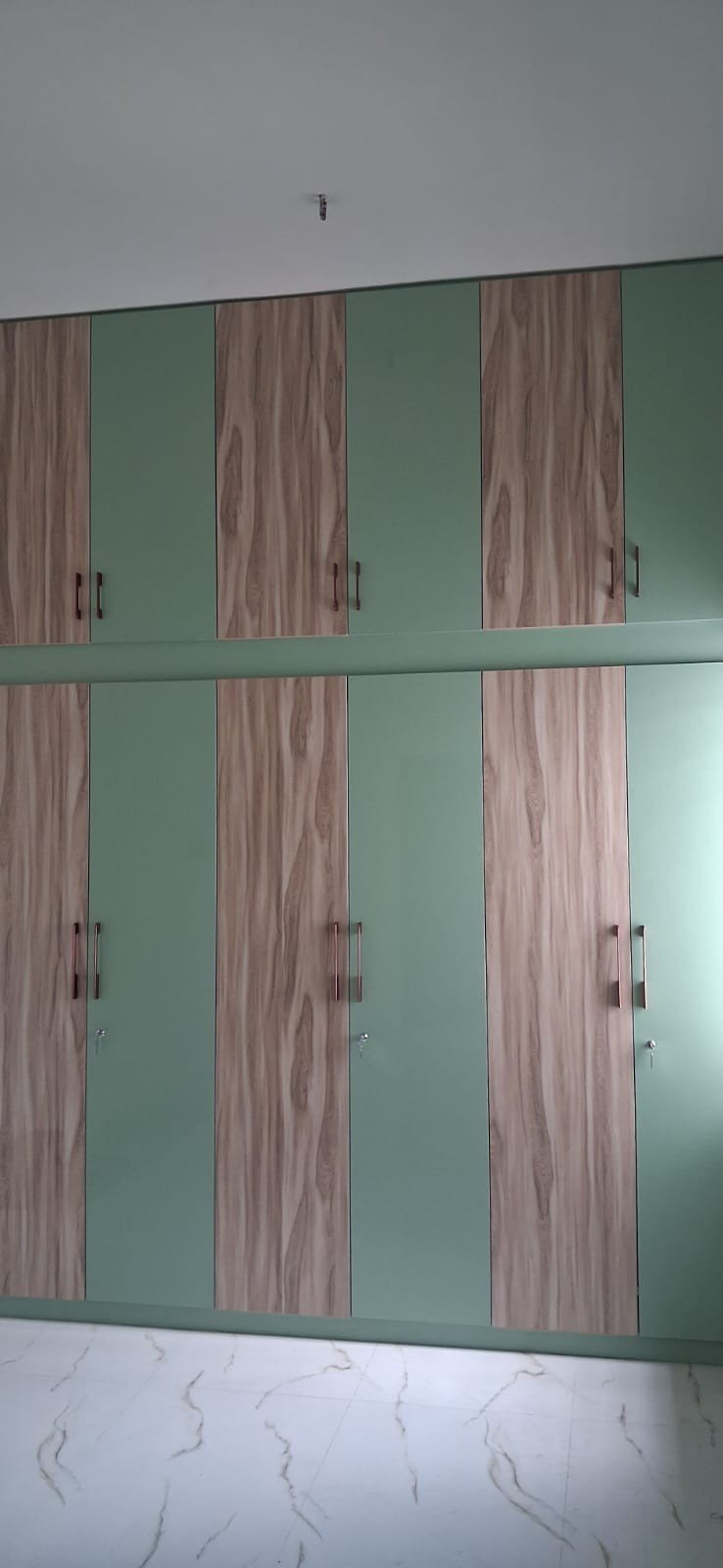 Blue glossy wardrobe design completed project by Anjaneya Interiors