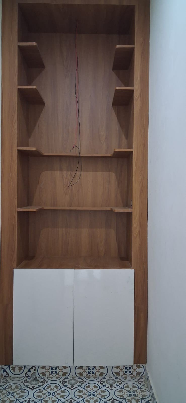 Open shelf storage unit design by Anjaneya Interiors and Furniture