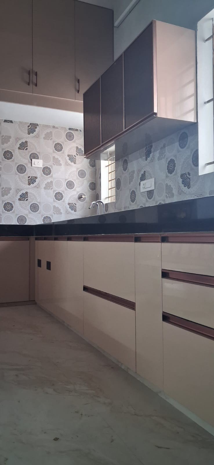 L-shape modular kitchen with cream cabinets by Anjaneya Interiors